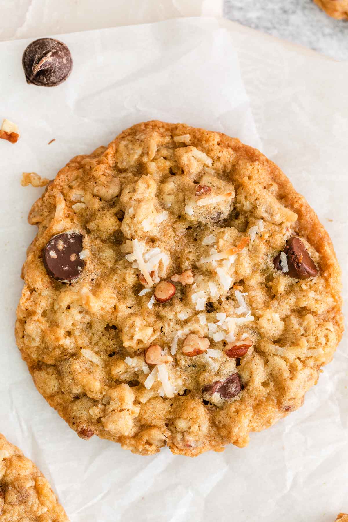 closeup of a cowboy cookies with chopped pecans, chocolate chips, oats and coconut