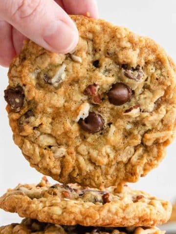closeup of an oatmeal cookie with chocolate chips, pecans and coconut.