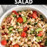 closeup of white bean salad with tomatoes, cucumbers and feta cheese with text overlay that read Mediterranean white bean salad.