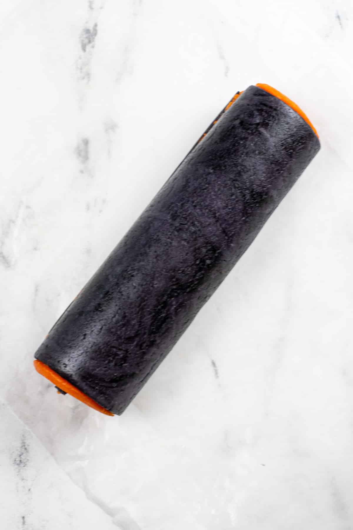 a roll of black cookie dough