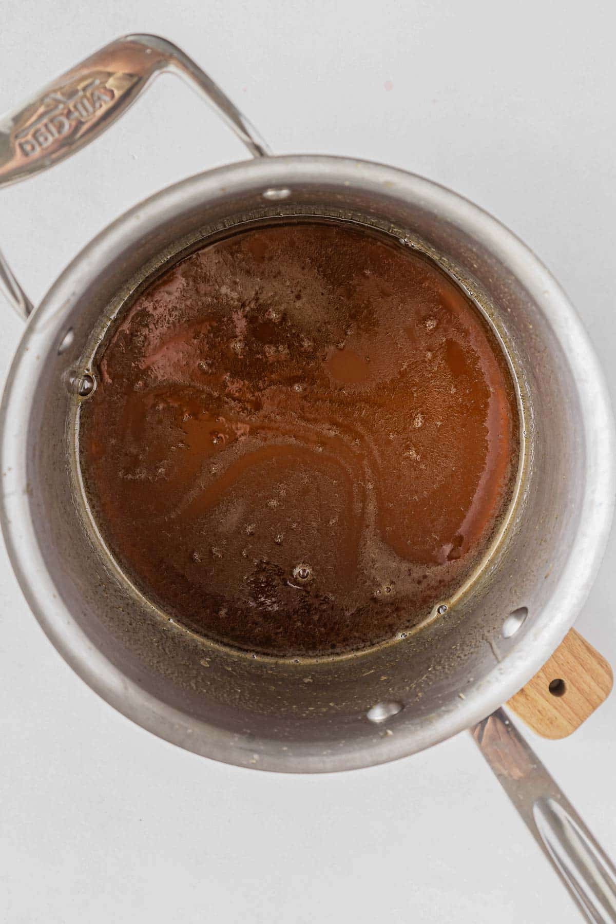 honey brown sugar glaze heated in a silver pot.