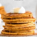 stack of five pumpkin pancakes with syrup dripping down the side
