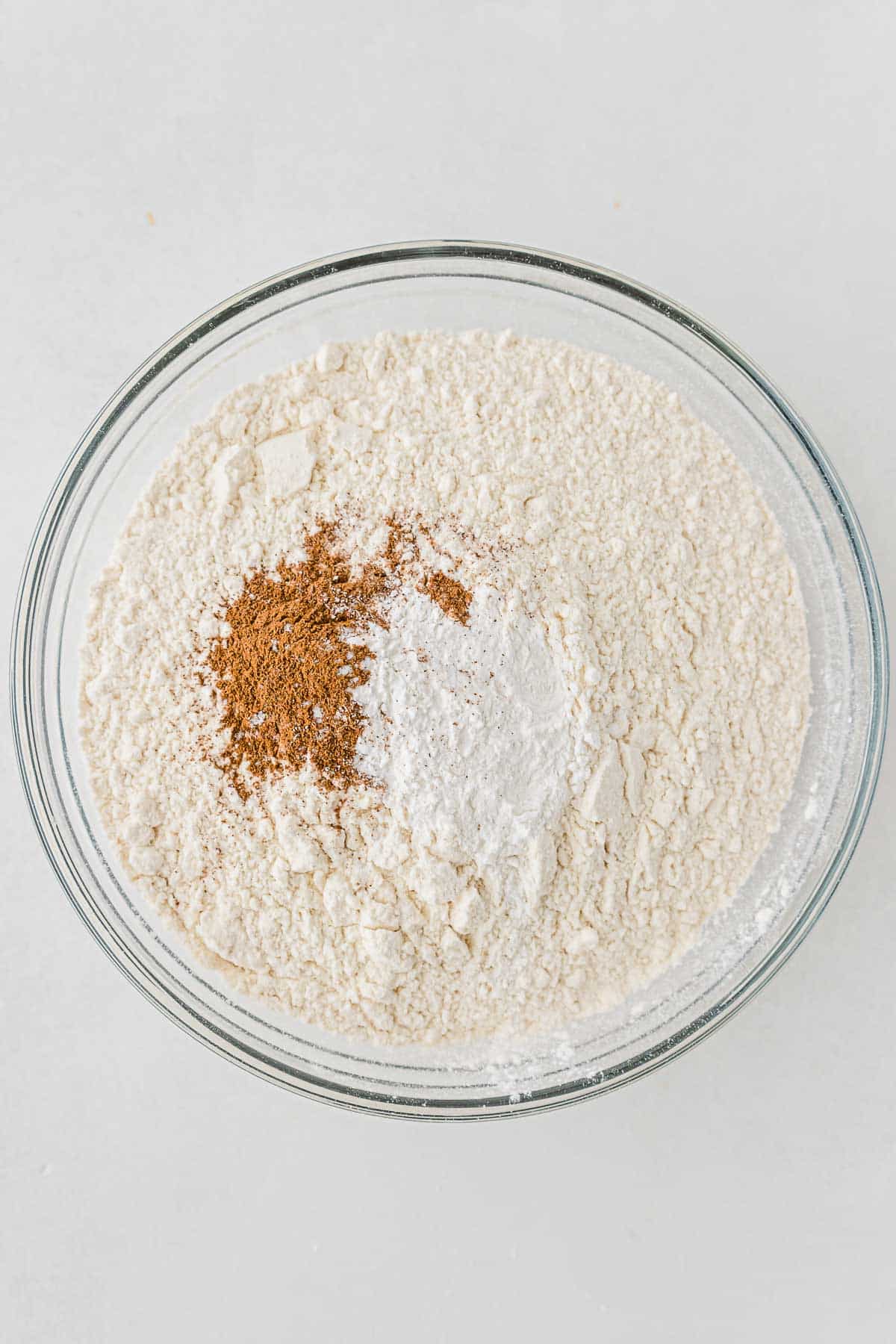 glass mixing bowl with flour and cinnamon.