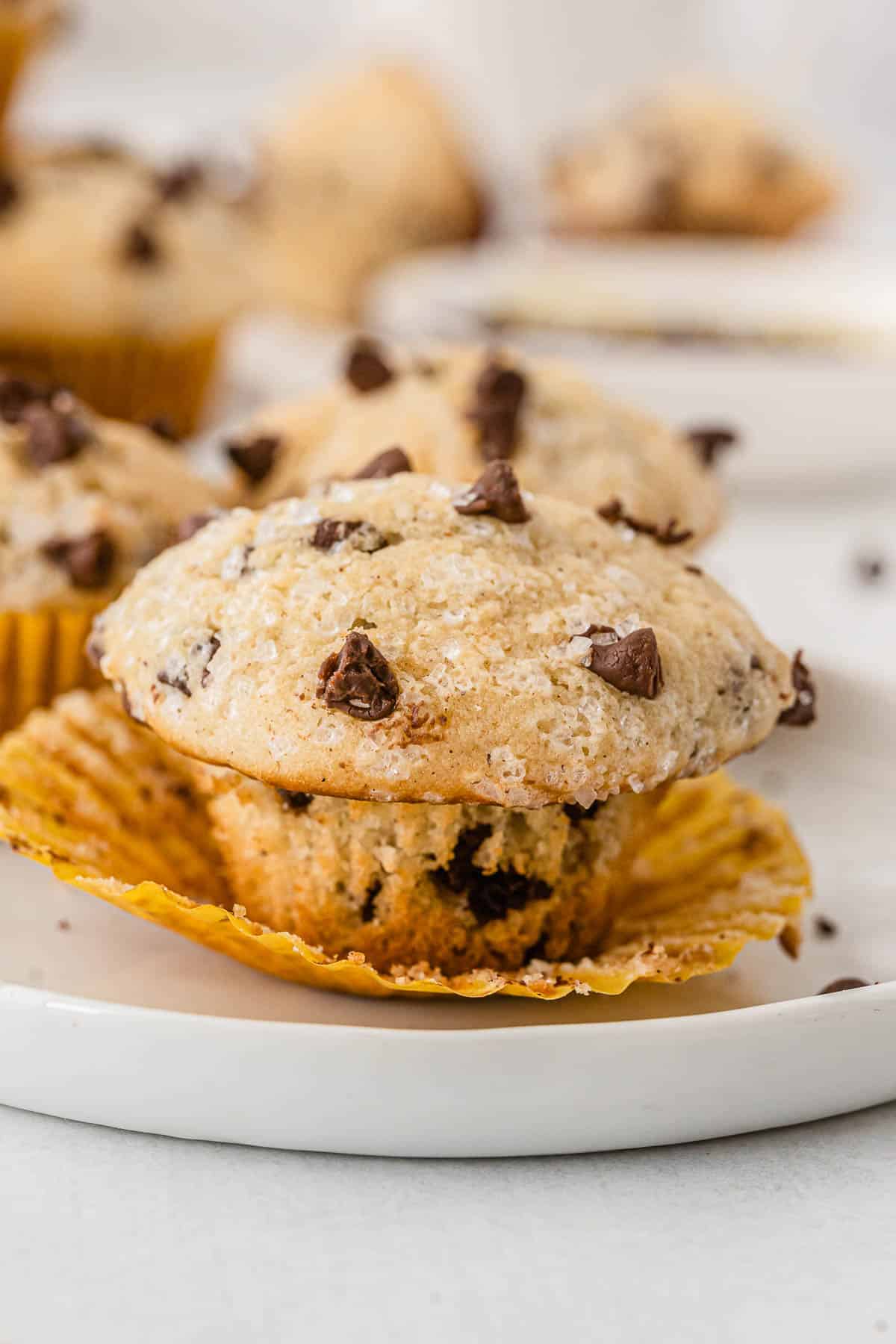 closeup of a chocolate chip mini muffin with the wrapper peeled off.