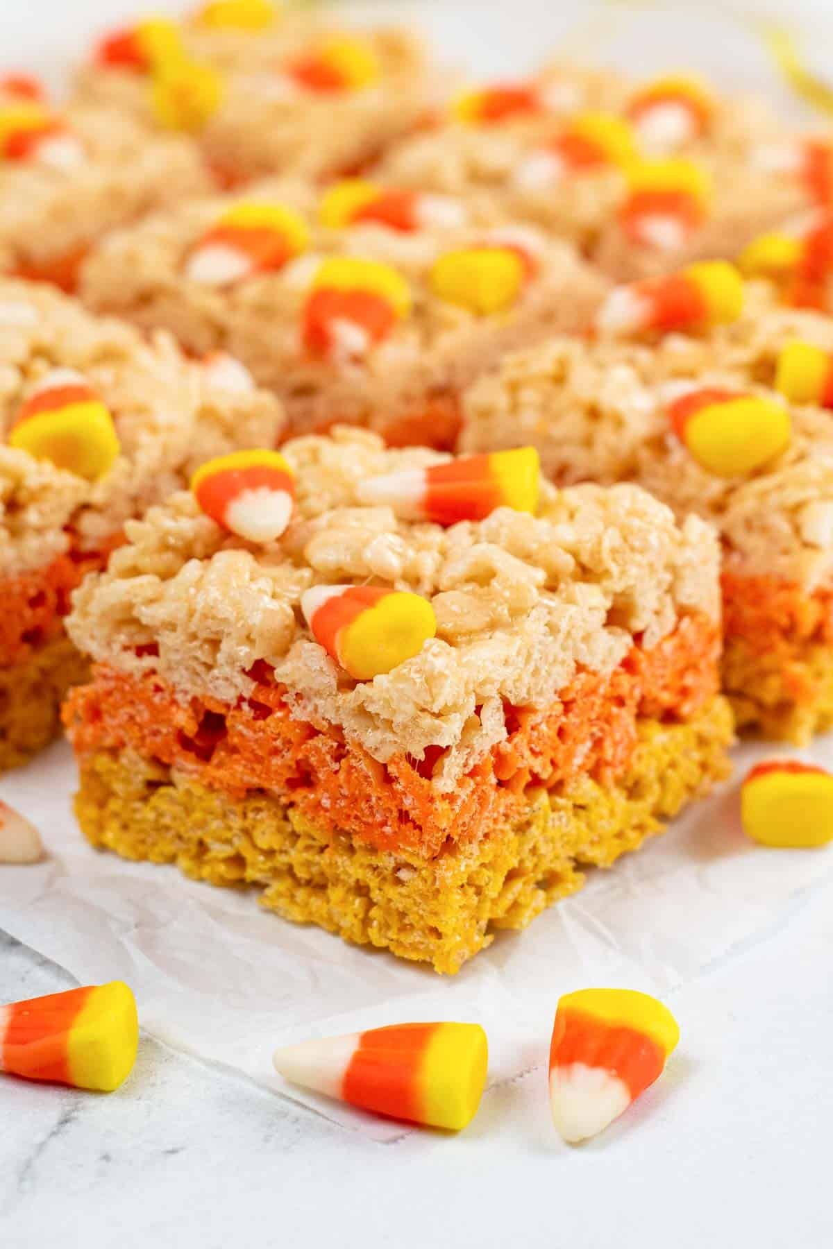 closeup of candy corn rice krispie treat with yellow, orange and white layers