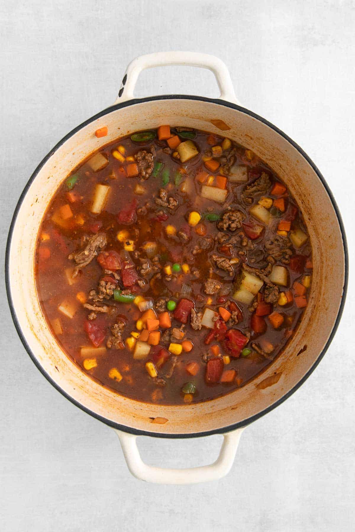 soup pot full of hamburger soup with vegetables.