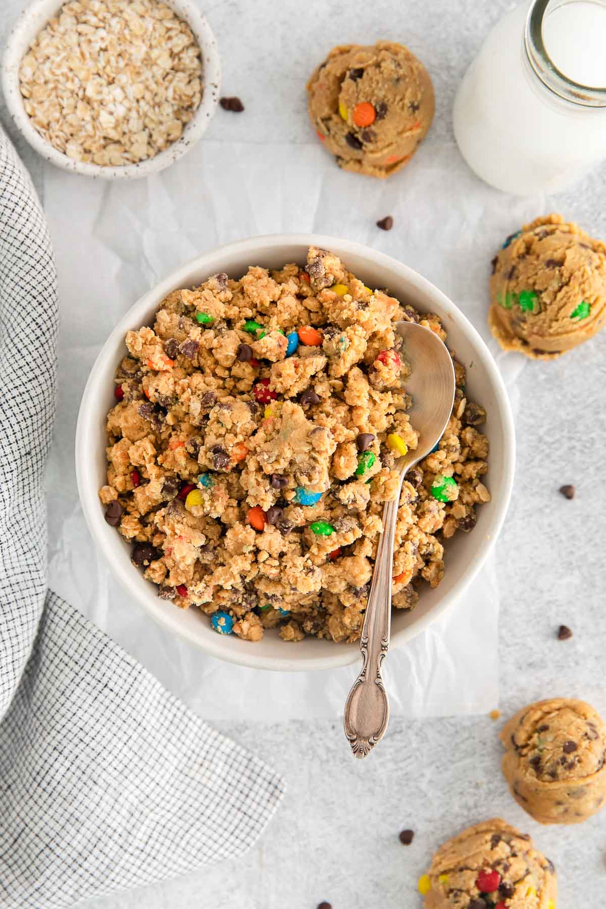 white bowl full of edible peanut butter cookie dough with chocolate chips and M&M's.