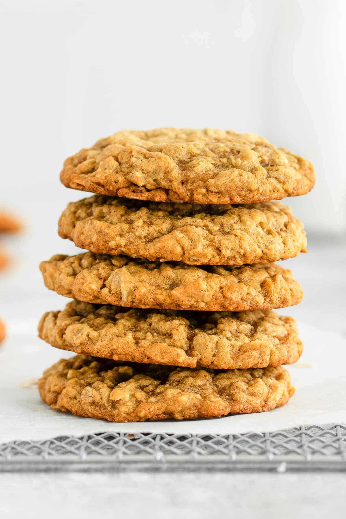 stack of five pumpkin cookies stacked on wire rack.