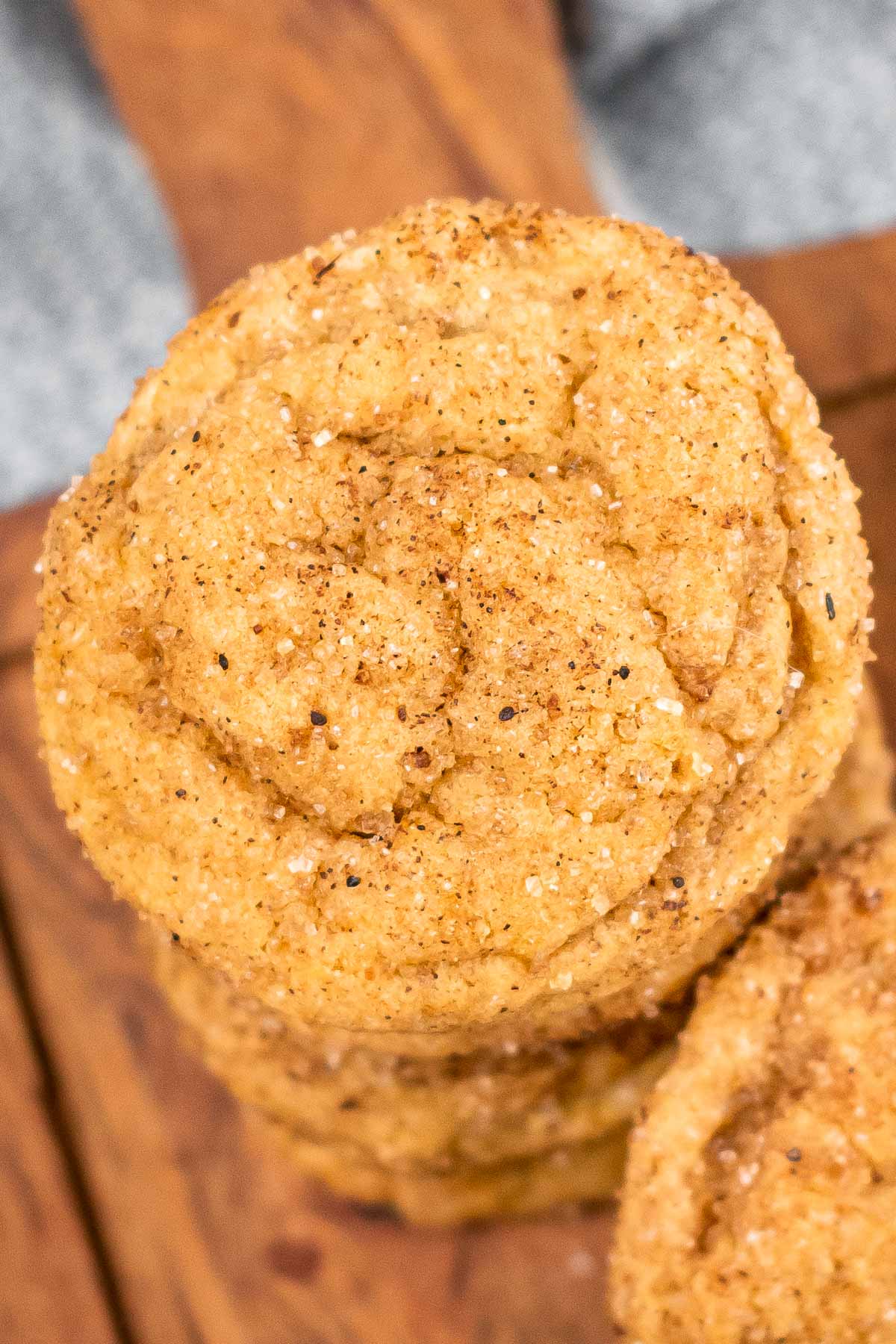 closeup of a pumpkin snickerdoodle cookie on top of a stack