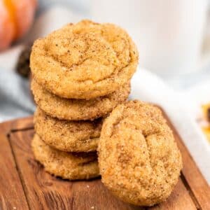 stack of pumpkin snickerdoodle cookies on a wood cutting board