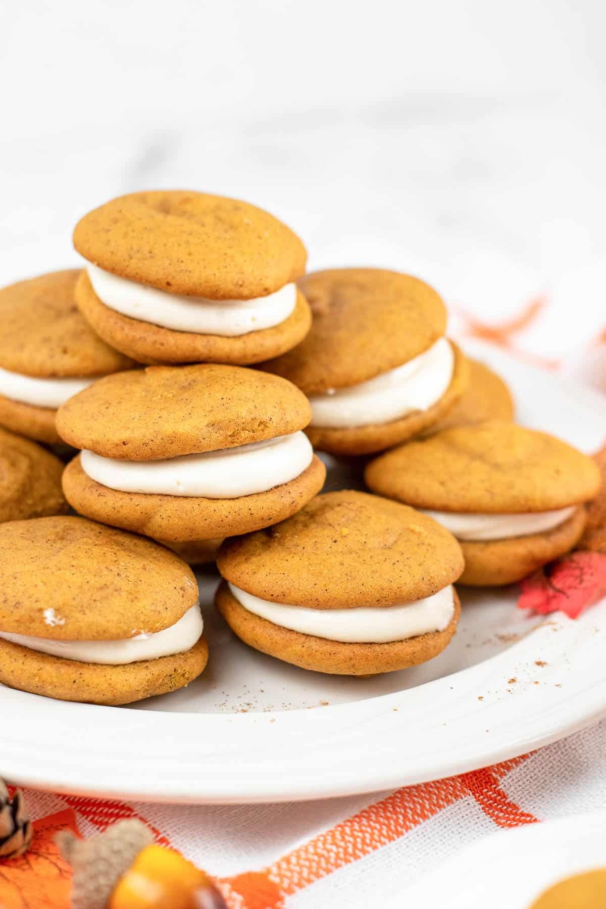 stack of several small whoopie pie on a white plate.