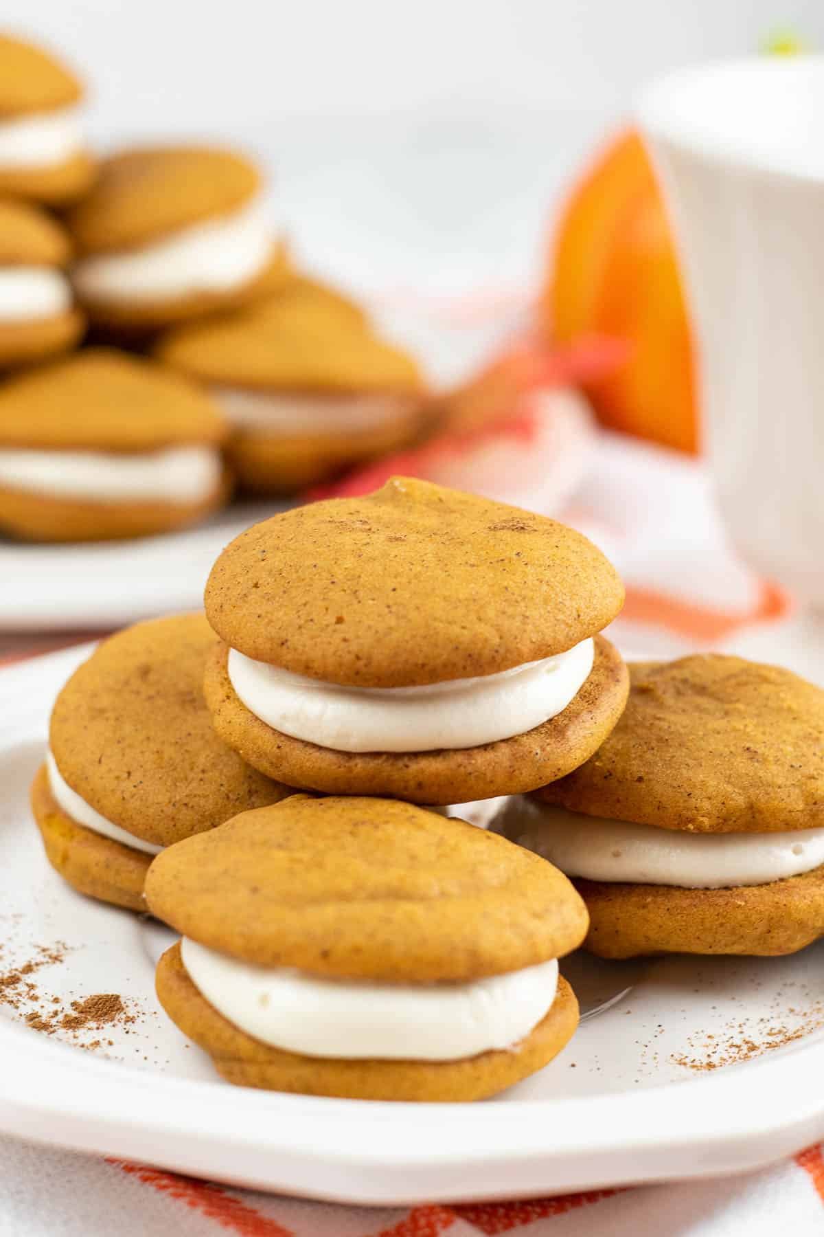 four mini whoopie pies on a white plate.