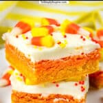 two yellow, orange and white layered cookie bars with candy corn on top