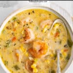 closeup of corn chowder with shrimp in a white bowl