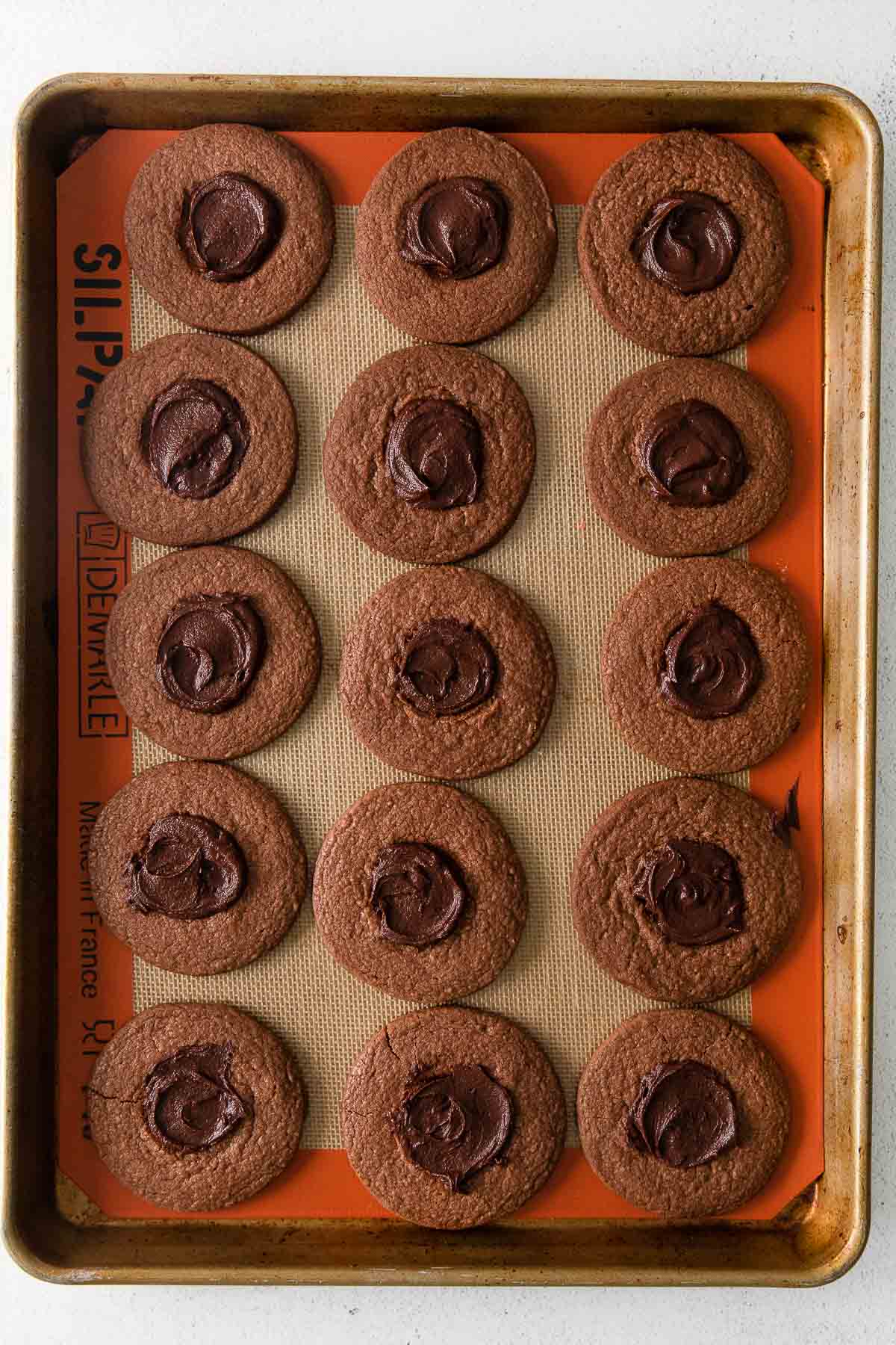 fifteen chocolate thumbprint cookies with chocolate ganache filling.