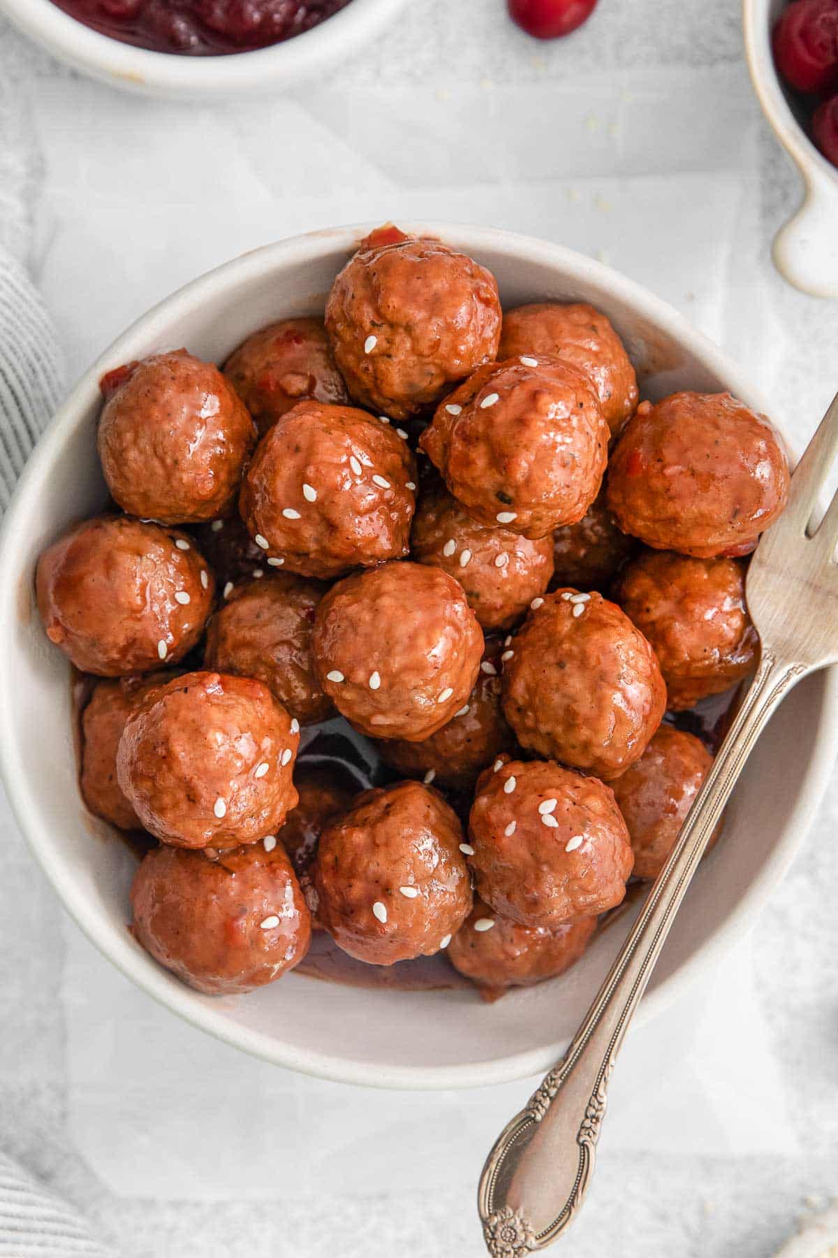 white bowl full of cranberry sauce meatballs.