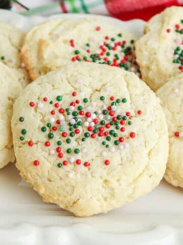 closeup of cream cheese cookies with red white and green sprinkles.