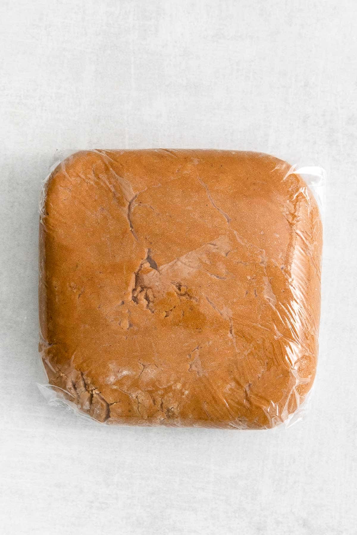 gingerbread cookie dough wrapped in plastic wrap.
