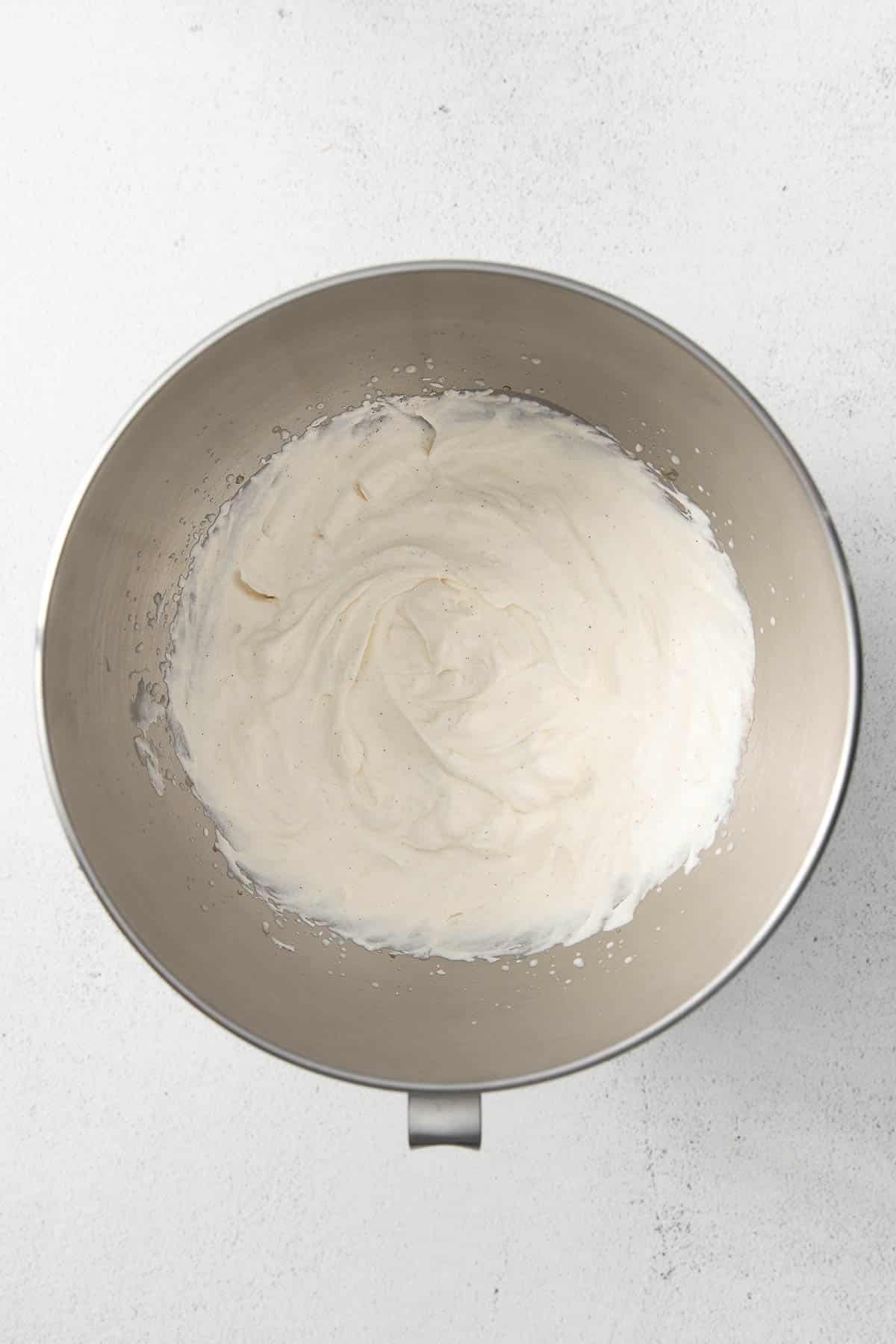 silver mixing bowl with whipped cream.
