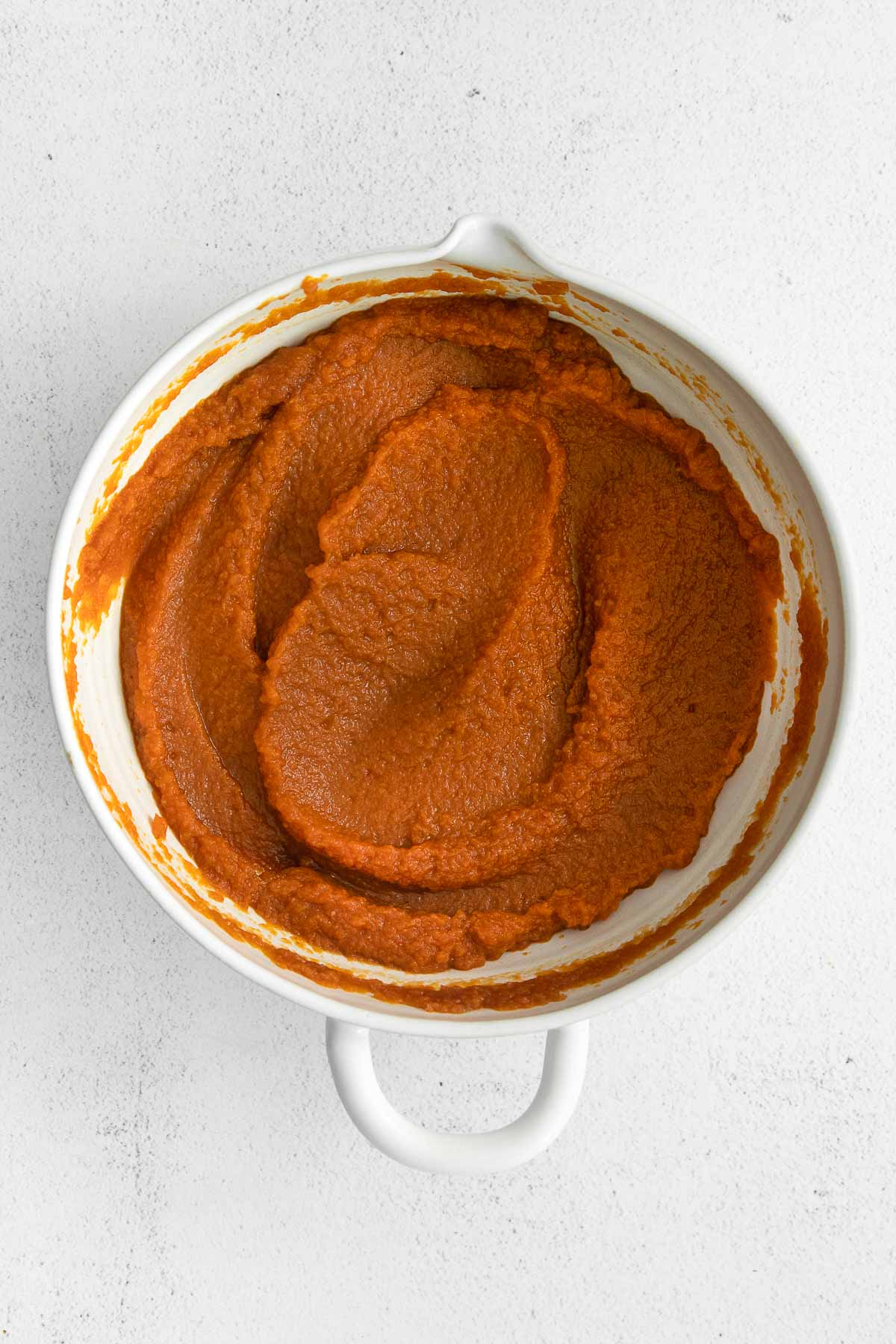 pumpkin puree mixture in a white mixing bowl.