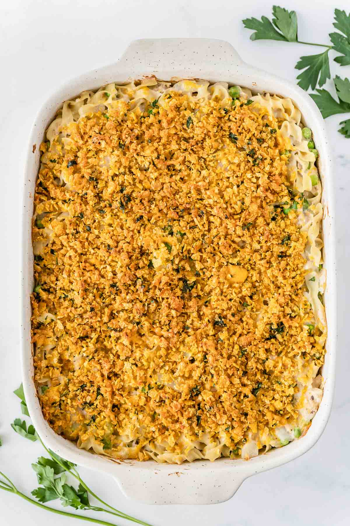 rectangle casserole dish with creamy tuna noodle mixture topped with a crunchy topping.