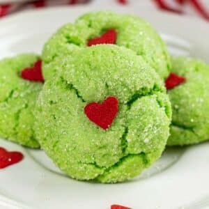 fluffy green cookie with sugared exterior and a red candy heart in the center.