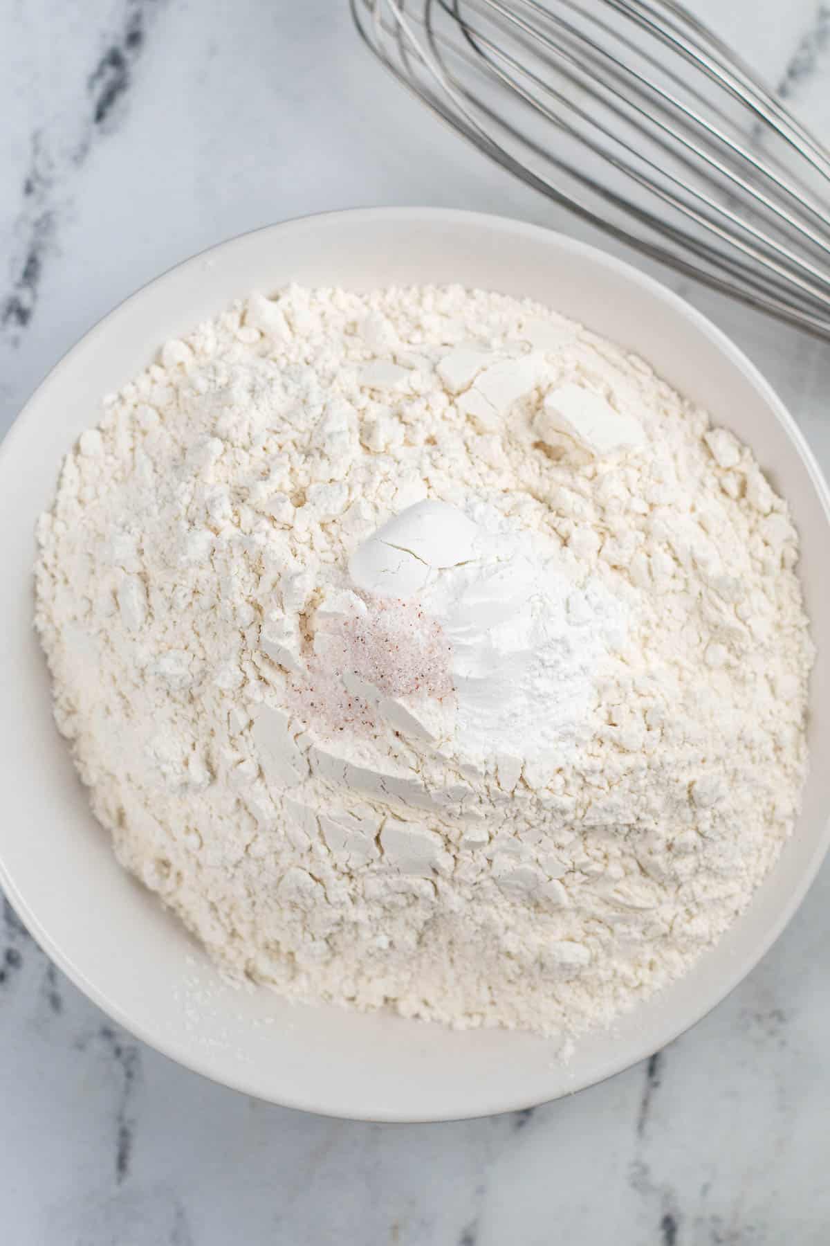 white bowl with flour, baking soda and salt.
