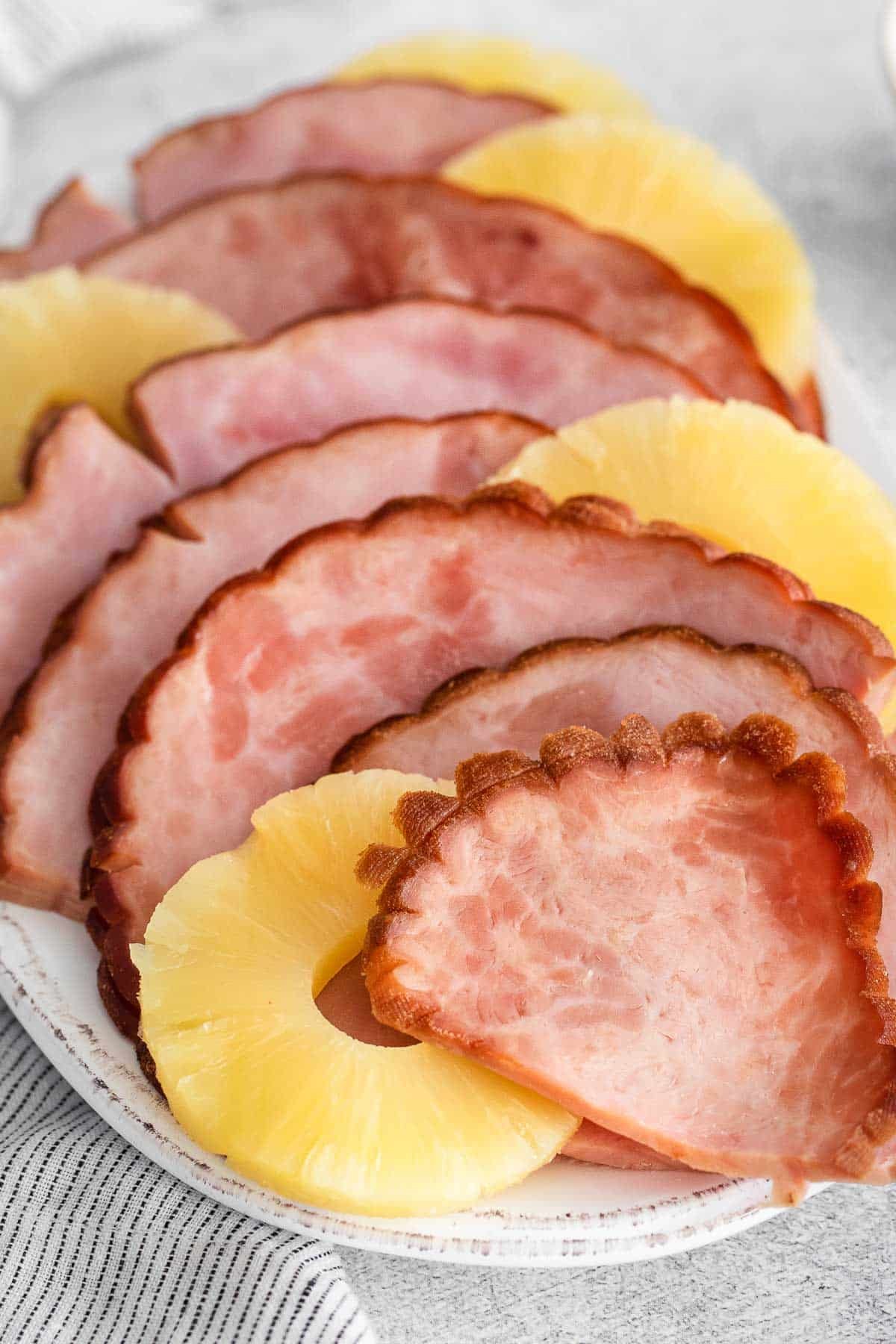 closeup of ham slices and pineapple slices on a platter.