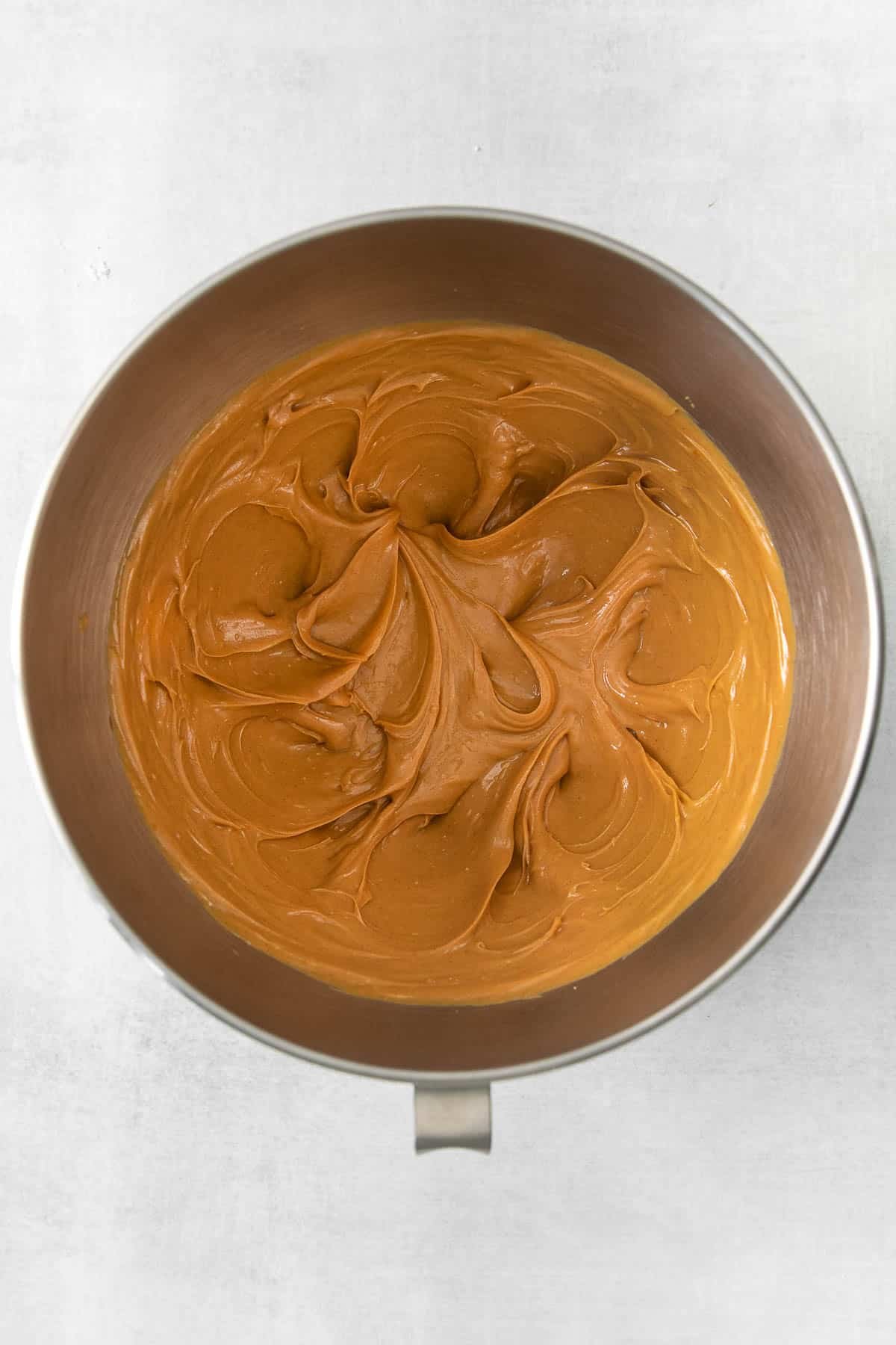 silver mixing bowl with fluffy whipped peanut butter mixture.