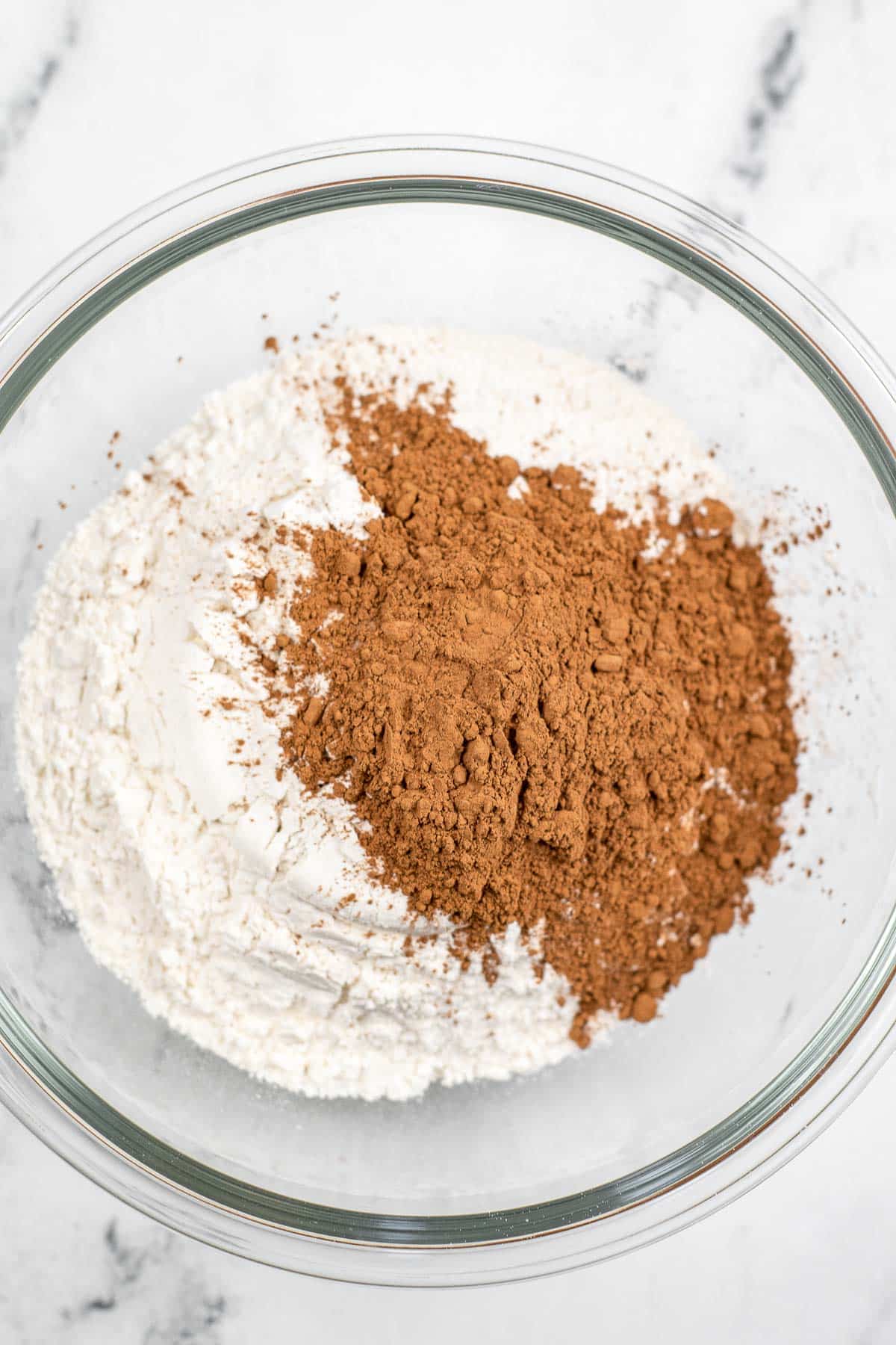 glass mixing bowl with flour and cocoa powder.