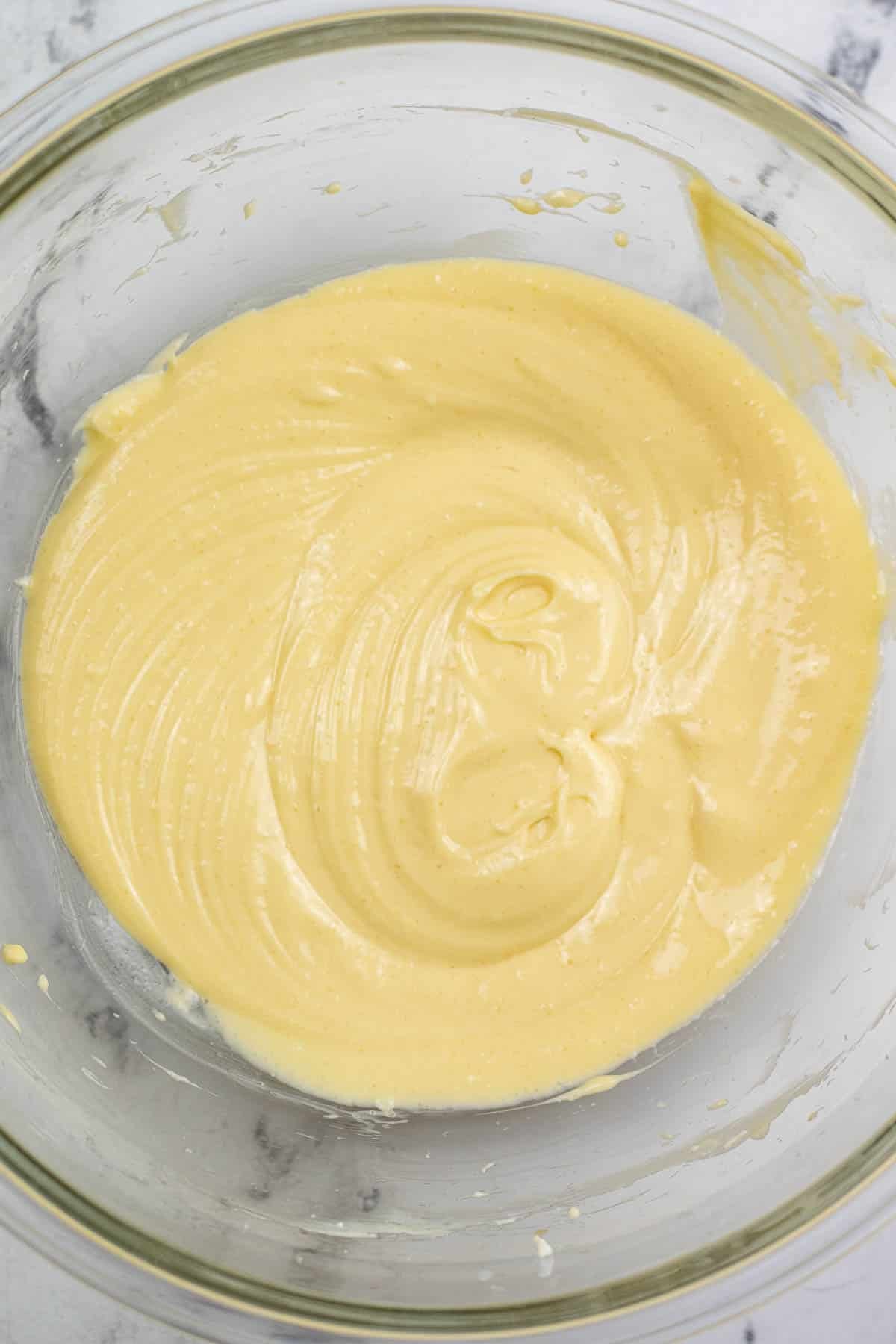cream cheese mixture in a glass mixing bowl.
