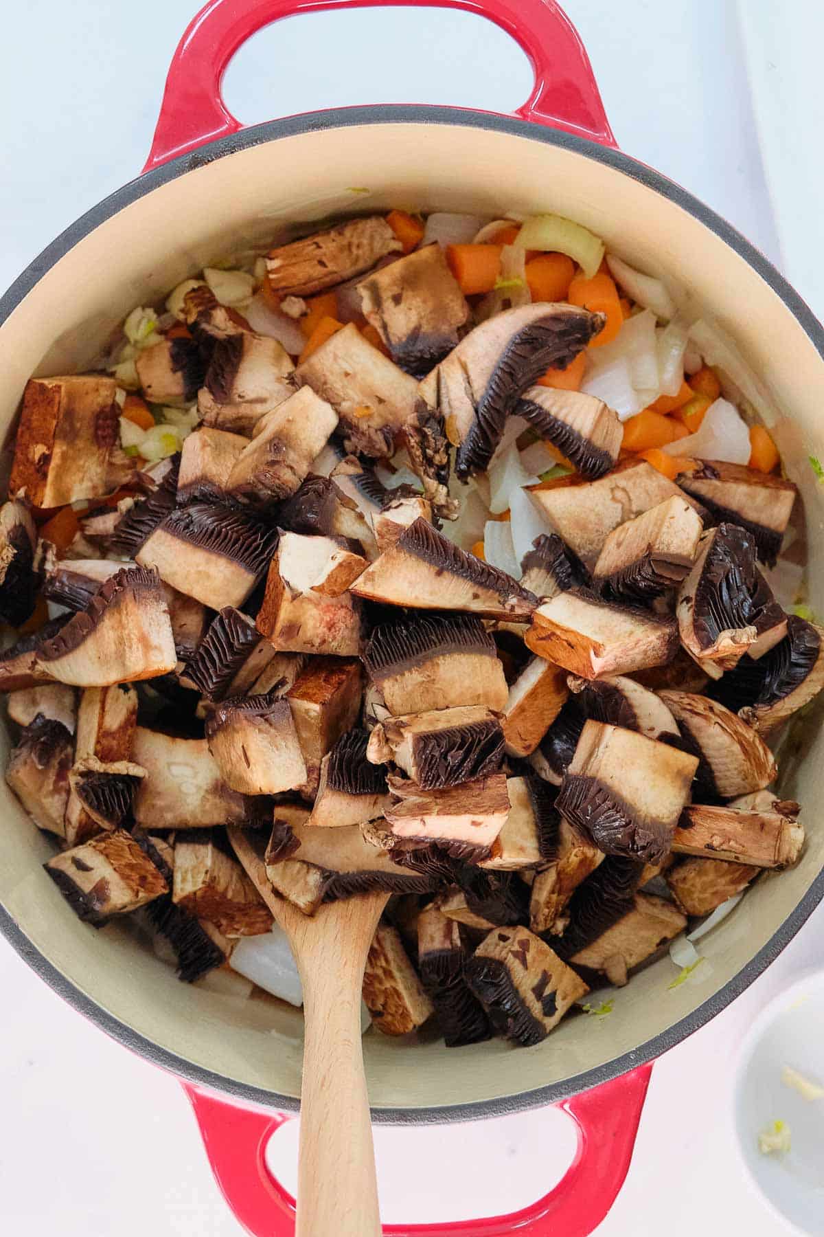 diced portobello mushroom in a soup pot.