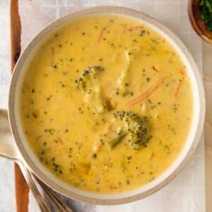 closeup of broccoli cheese soup in a white bowl.