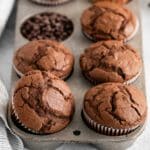 closeup of eight chocolate muffins in a muffin tin.