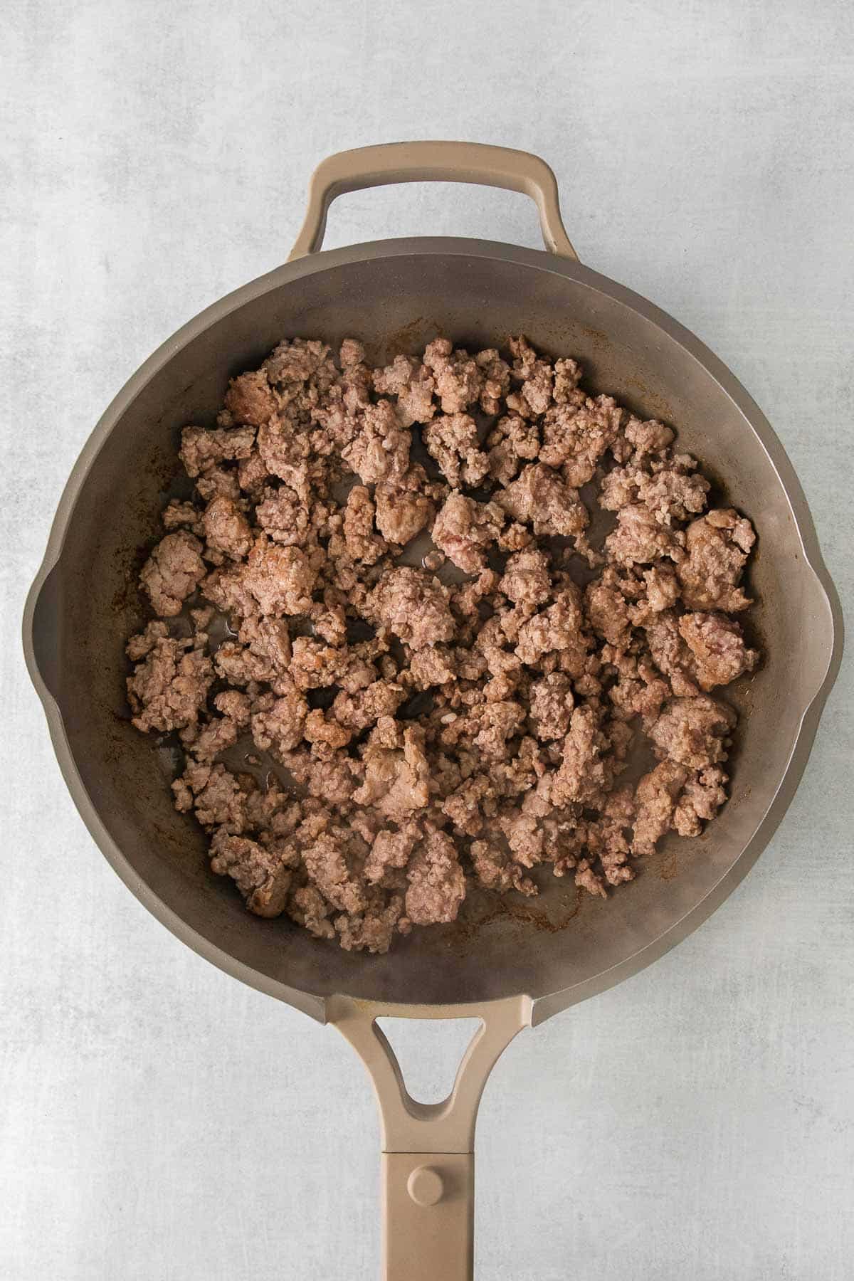 gray skillet with ground cooked pork.