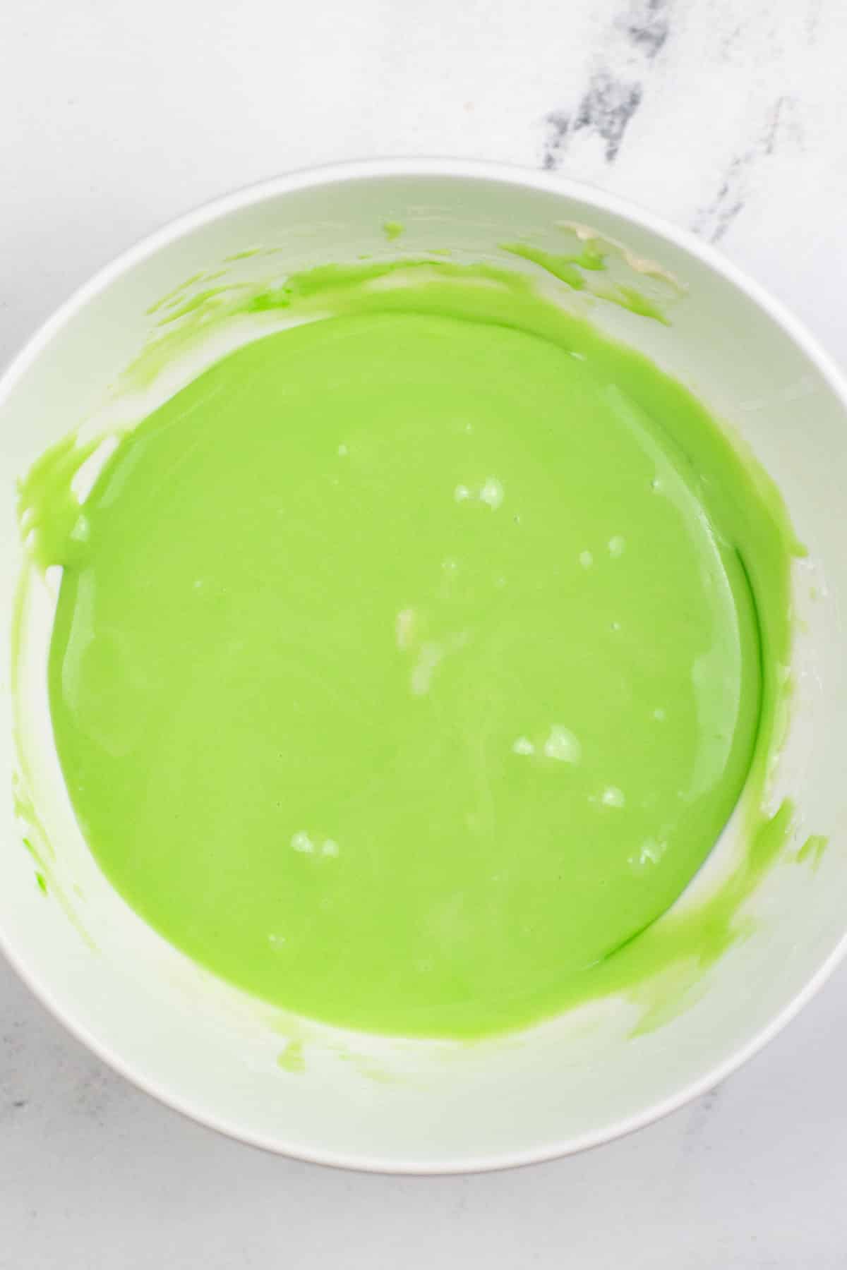 green icing in a white bowl.
