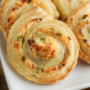 closeup of a puff pastry jalapeno popper pinwheel with cream cheese.