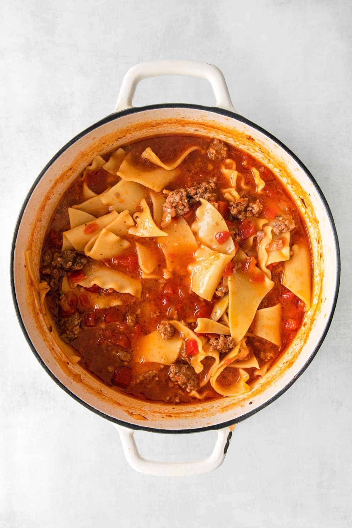white dutch oven with lasagna soup.