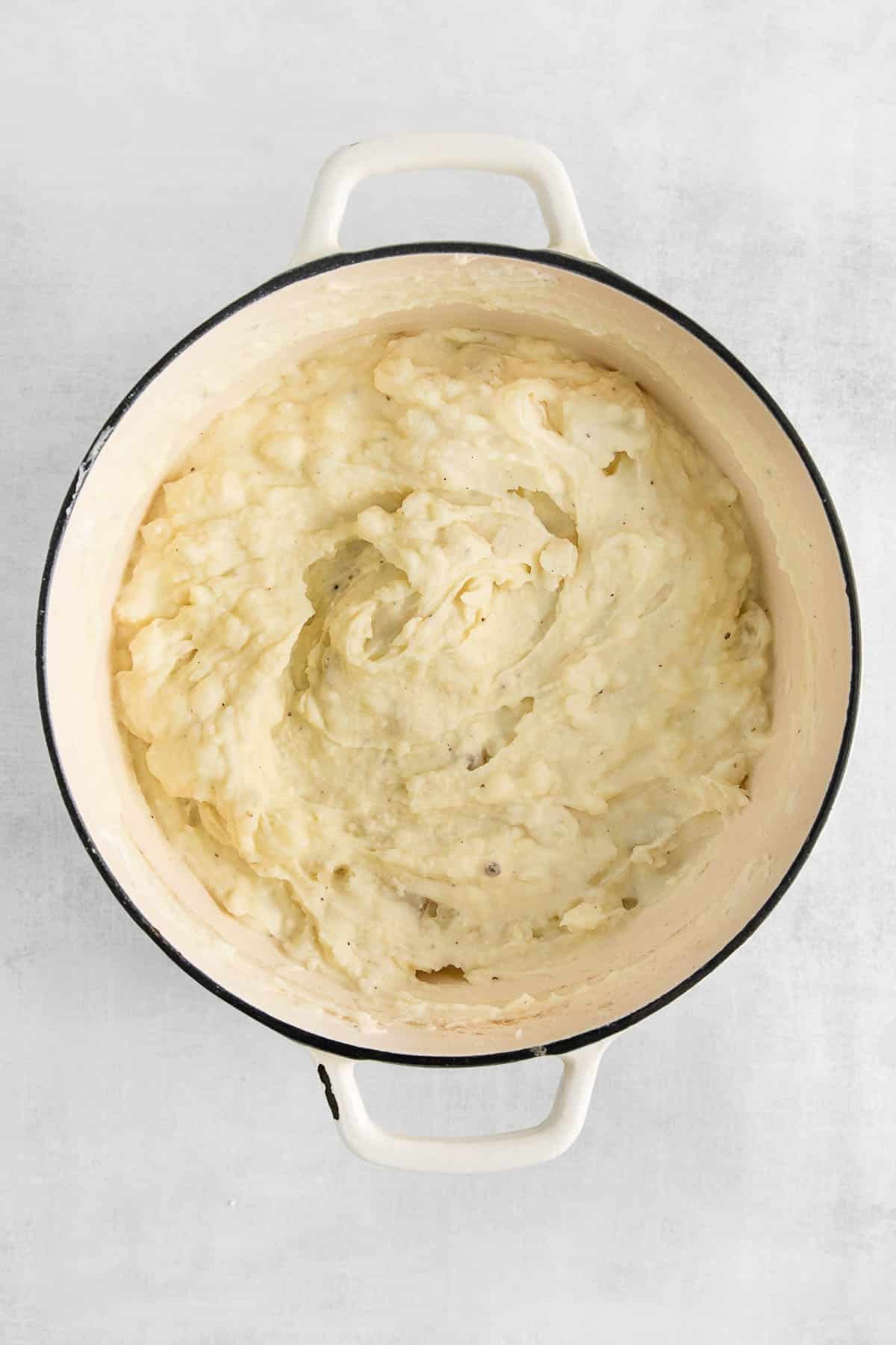 creamy mashed potatoes in a big white pot.