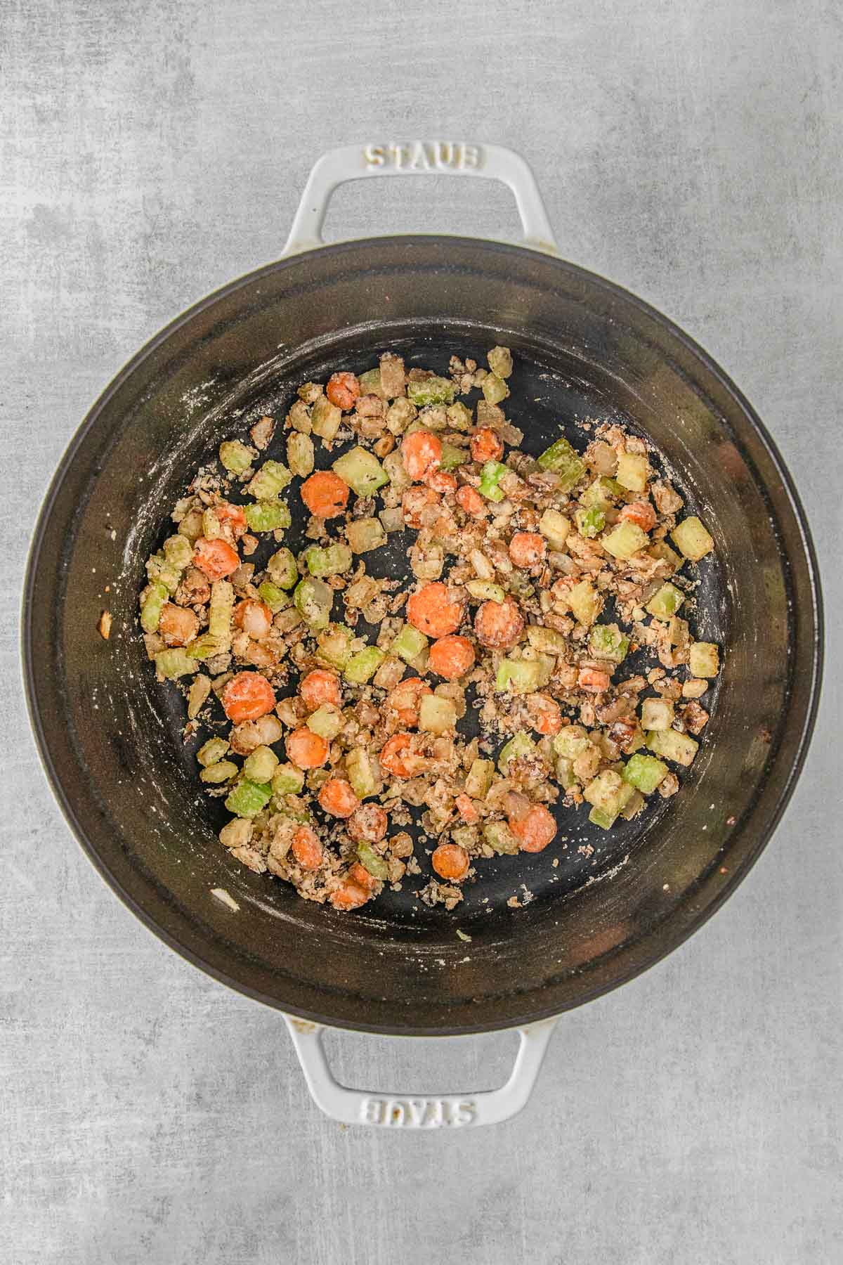 iron skillet with diced, cooked celery, carrots and onions.