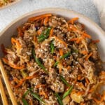 deconstructed egg roll in a bowl with chopsticks on the side of the bowl.