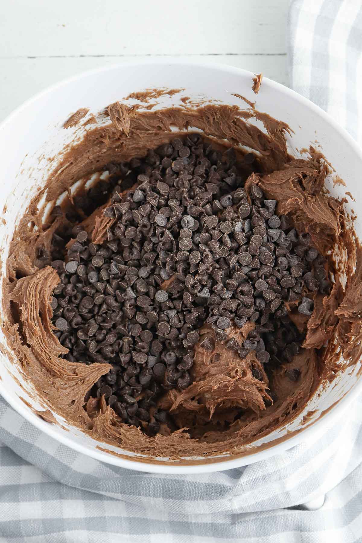 white mixing bowl with brownie batter with chocolate chips on top.