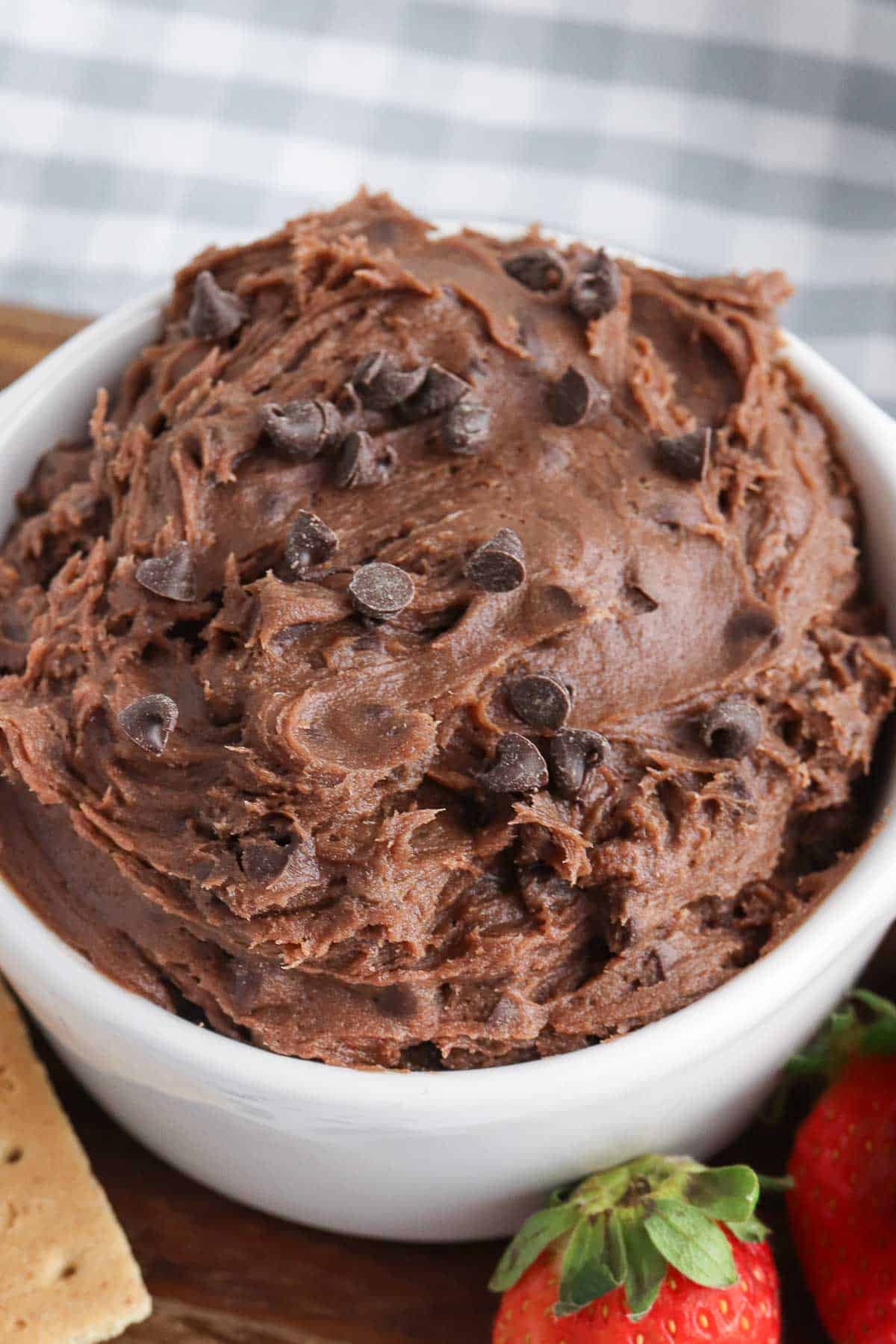 white bowl with chocolate brownie batter dip with chocolate chips mixed in.