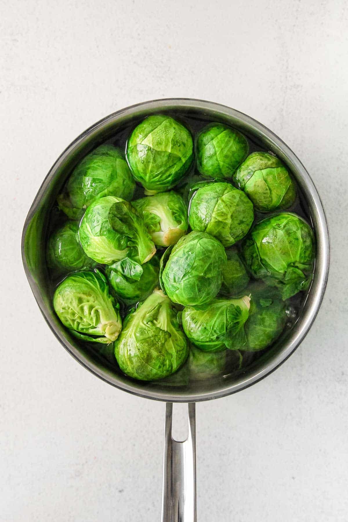 Cooking pot with brussel sprouts.