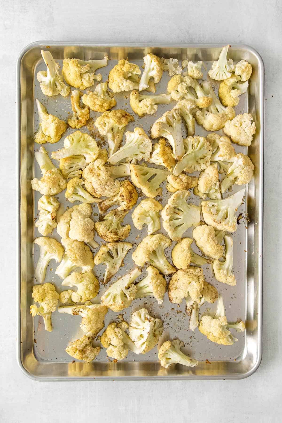 Baked Cauliflower florets on baking sheet.