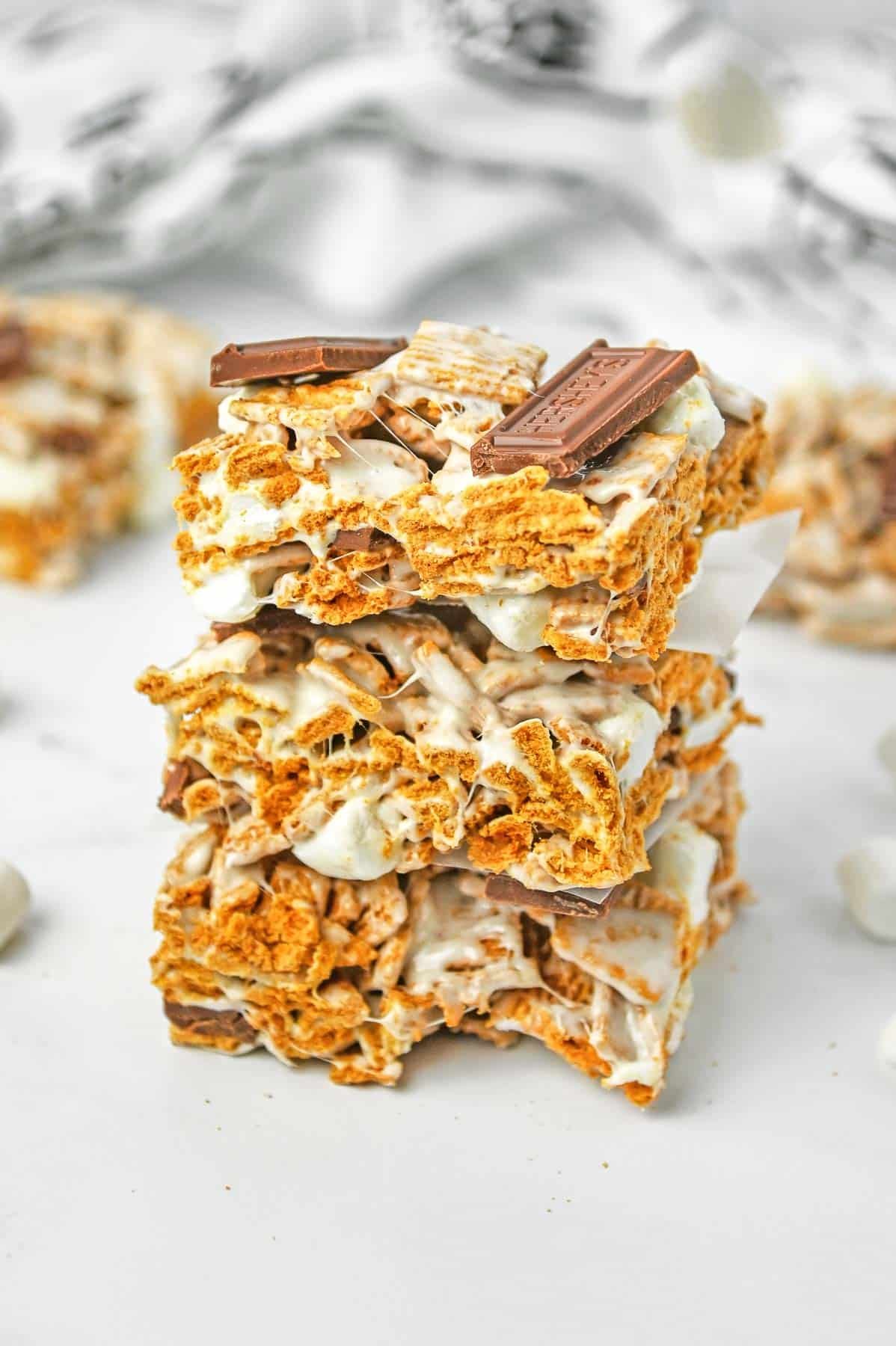 3 golden graham cereal bars stacked on top of each other.