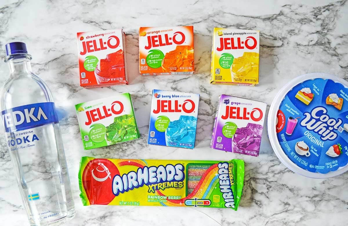 ingredients for Rainbow Jello Shots - cool whip, airheads xtremes, vodka and jello flavors.