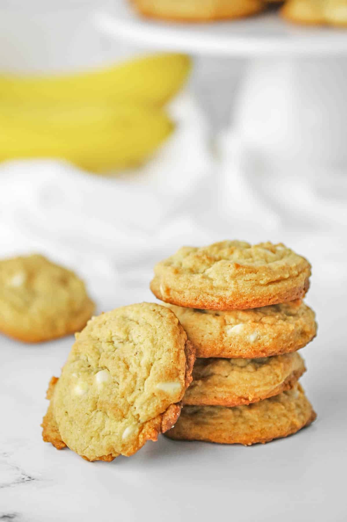 a stack of four banana pudding cookies with one leaning up against the stack.