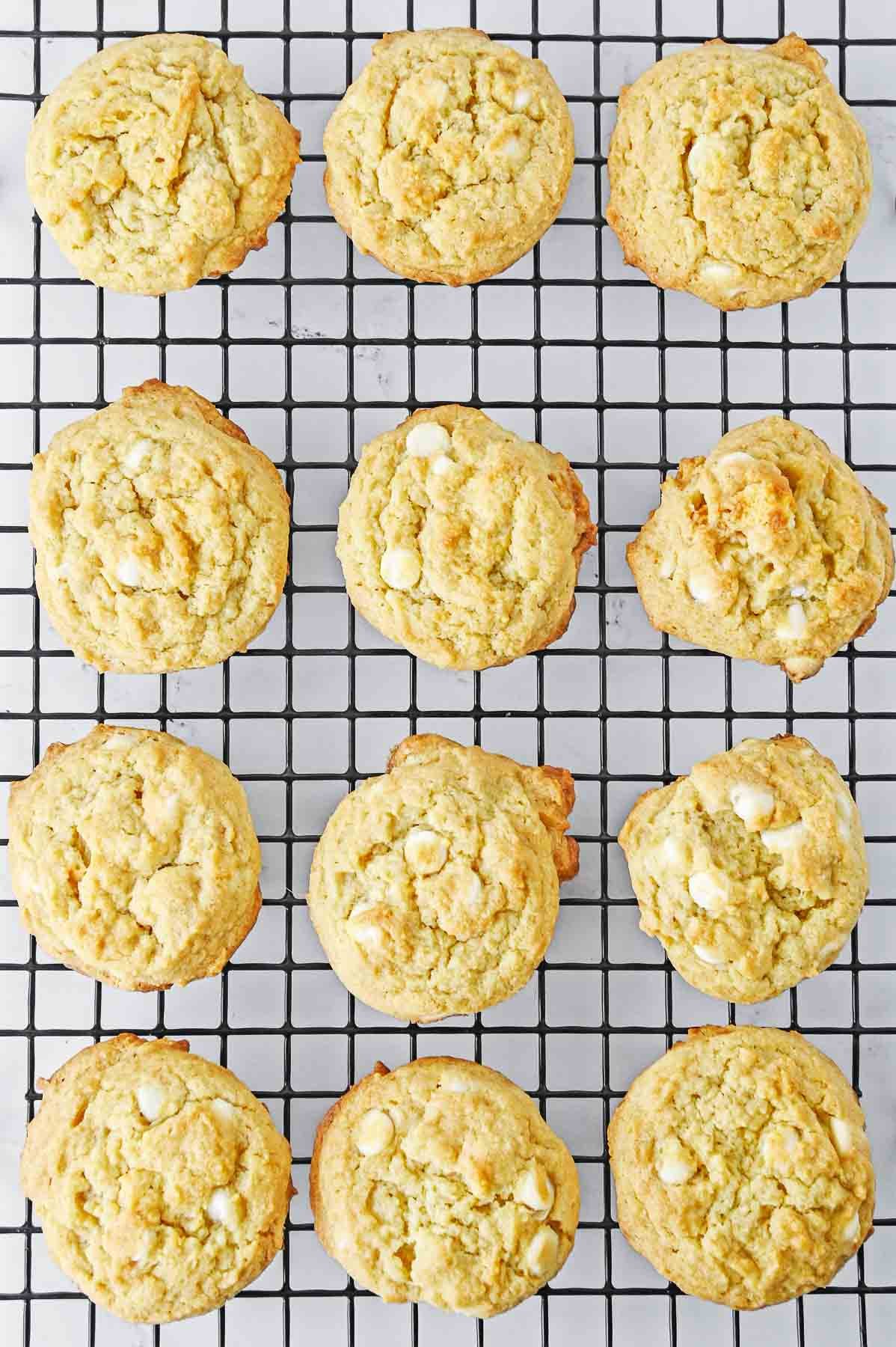 twelve banana cream pudding cookies on a wire cooling rack.