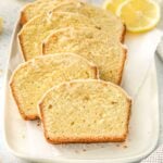 Multiple lemon pound cake slices laid on white plate.